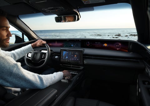 A driver of a parked 2024 Lincoln Nautilus® SUV takes a relaxing moment at a seaside overlook while inside his Nautilus. | Irwin Lincoln in Freehold NJ