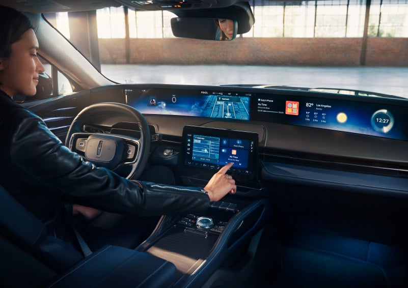 The driver of a 2024 Lincoln Nautilus® SUV interacts with the center touchscreen. | Irwin Lincoln in Freehold NJ